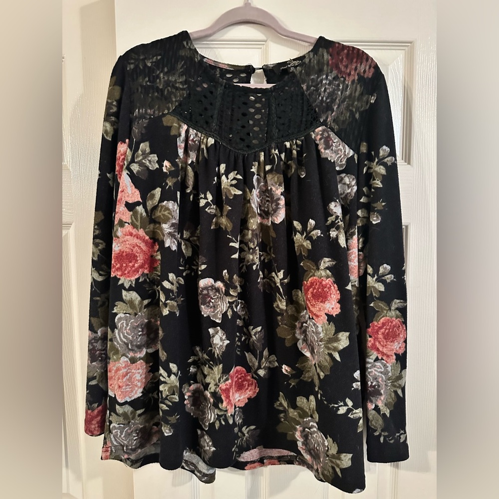 Warm, flowy floral top with embroidered neck accents.